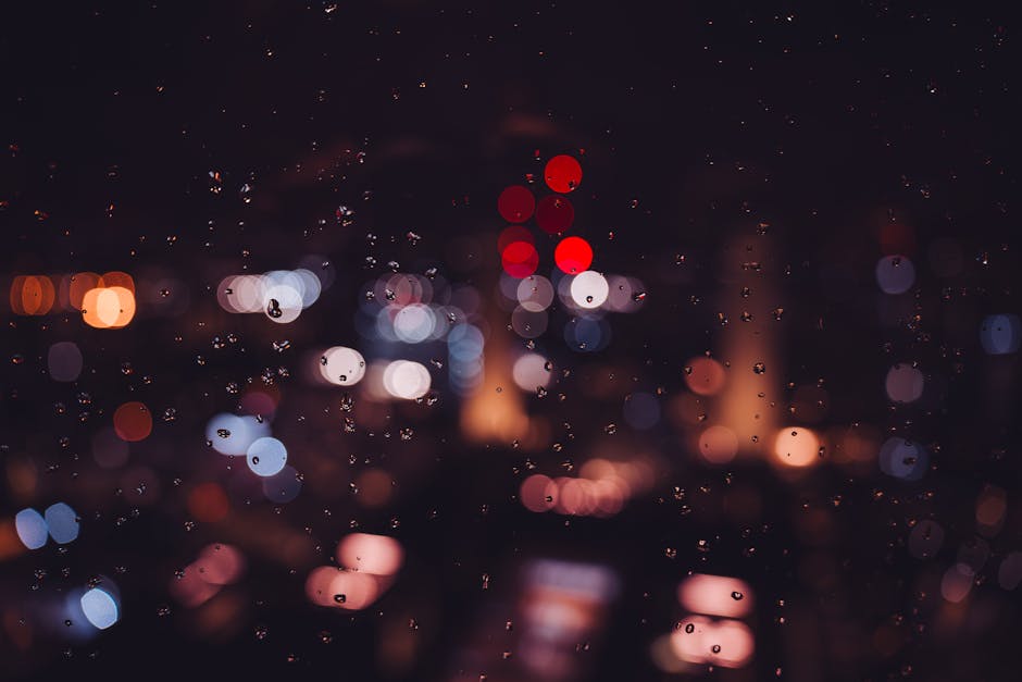 Bokeh city lights and raindrops on glass create a magical nighttime ambiance in London.