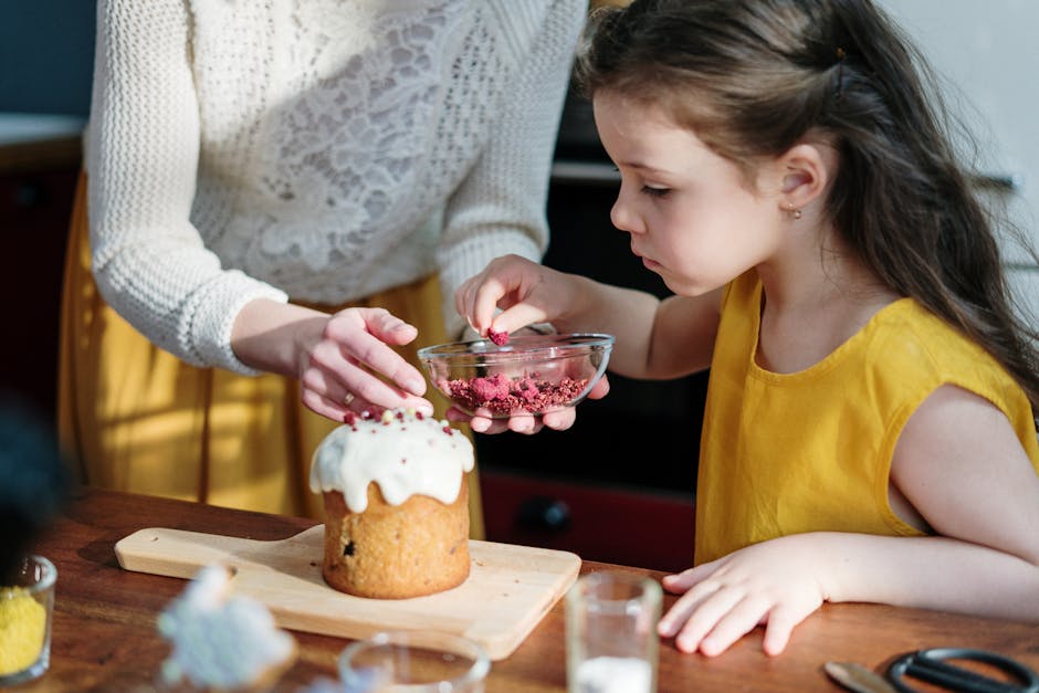 A mother and daughter bonding while decorating an Easter cake together indoors.