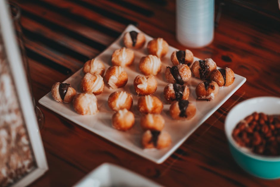 A plate of assorted brigadeiros displayed on a table in a São Paulo café.