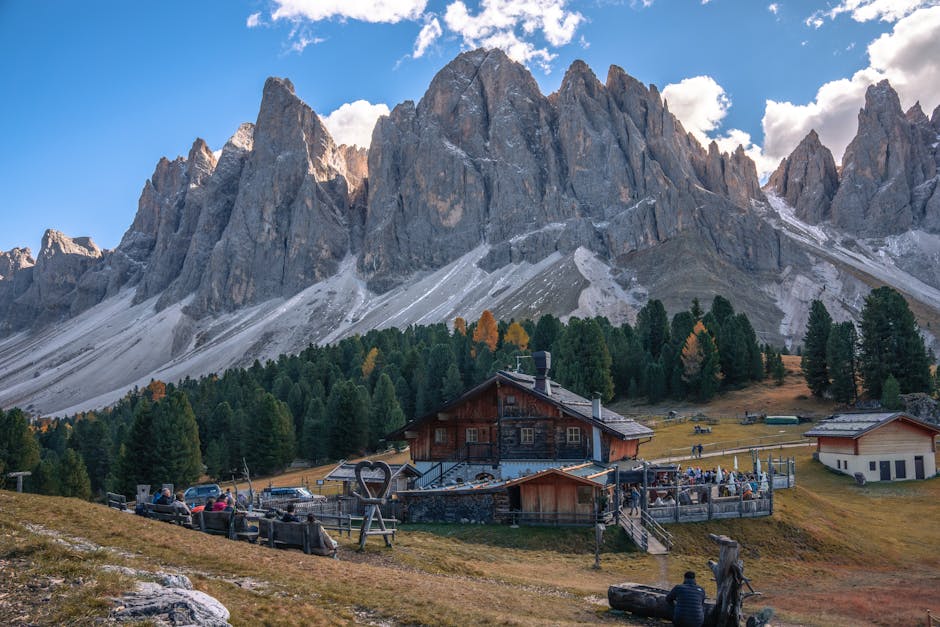Beautiful mountain view in the Dolomites with a rustic lodge nestled in the valley.